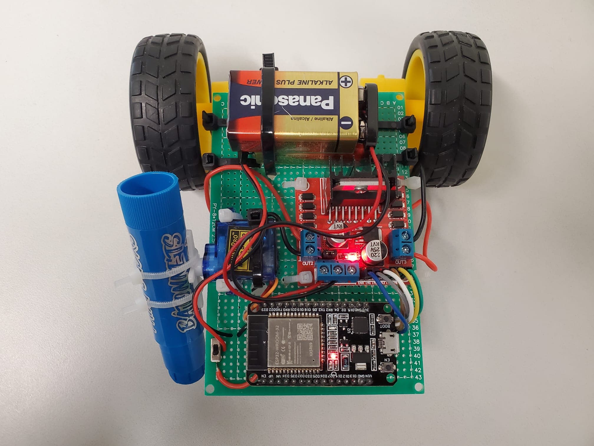 Top-down view: ESP32, motor driver, servo pen lift, 9V power